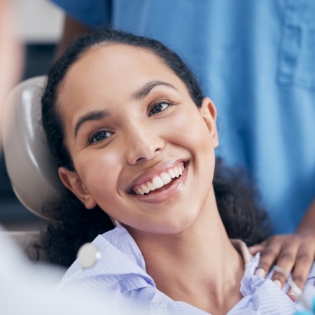 Young woman grinning in dental chair