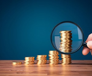 Coins examined with magnifying glass