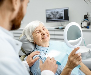 An elderly woman enjoying her new dental implant
