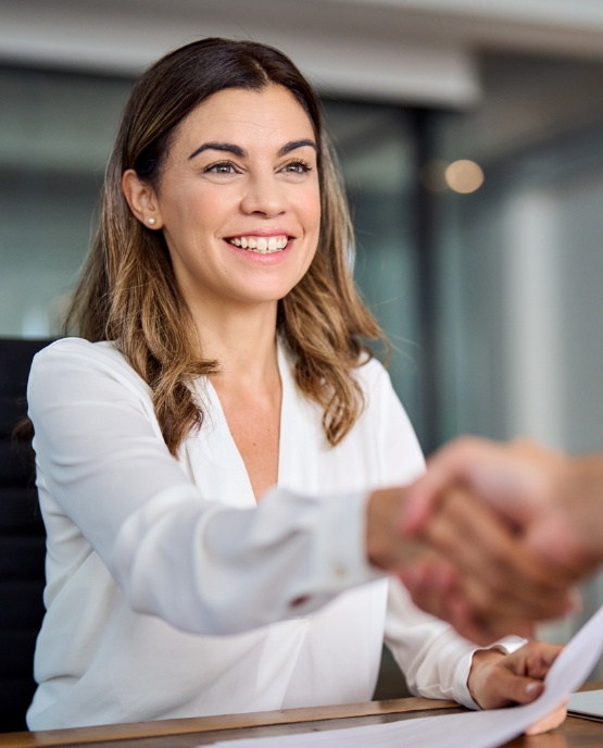 Dental team member shaking hands with a patient