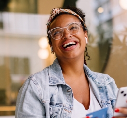 Woman in denim jacket laughing