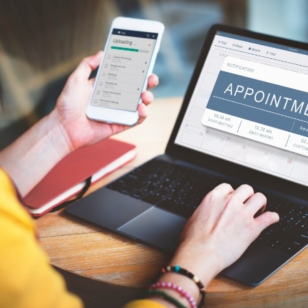 Person using laptop to book an online dental appointment in Falls Church