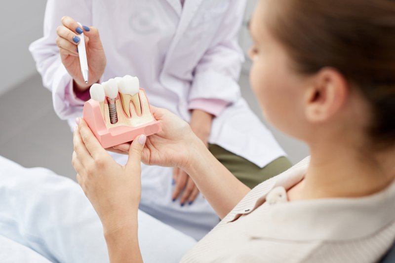 A dentist explaining dental implant surgery to a patient
